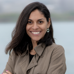 Priscila Pereira smiles toward the camera