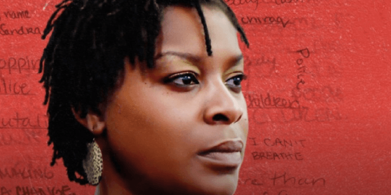 Image of Sandra Bland against a red wall with phrases