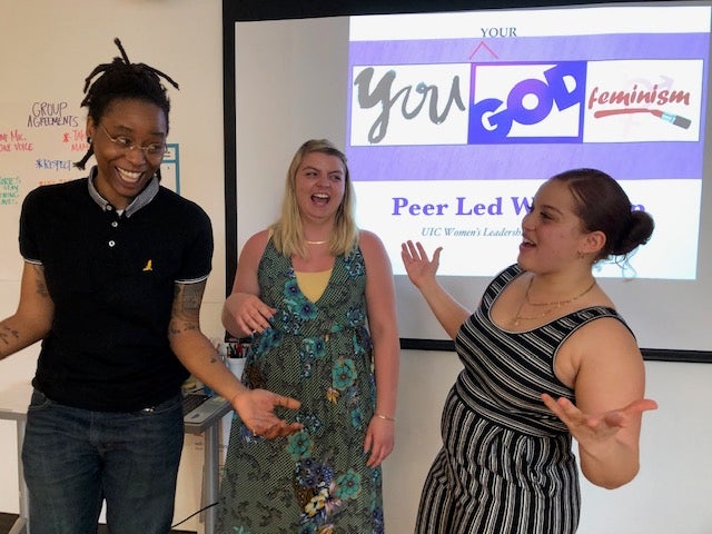 Three WLRC student employees laugh while co-presenting a workshop on Christianity and feminism