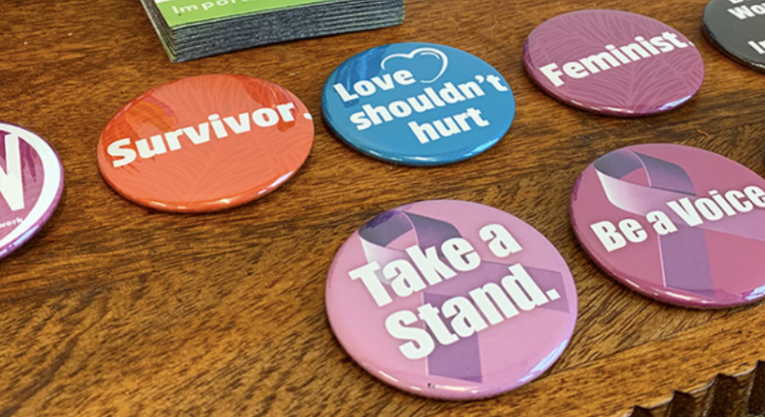 A wooden tabletop with CAN buttons with sayings like 